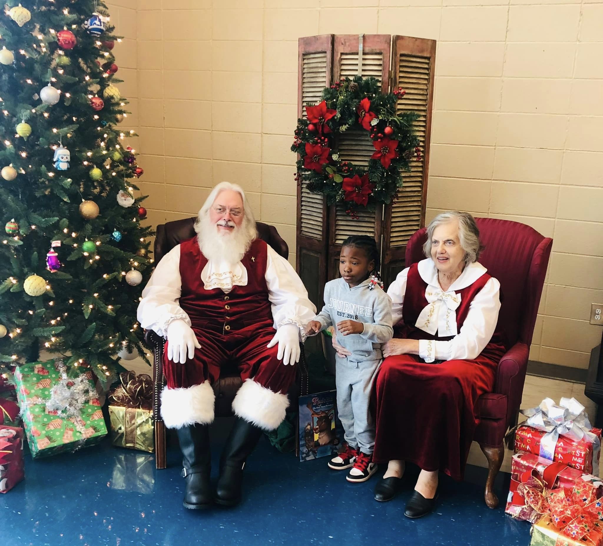 Mr. and Mrs. Santa with a child