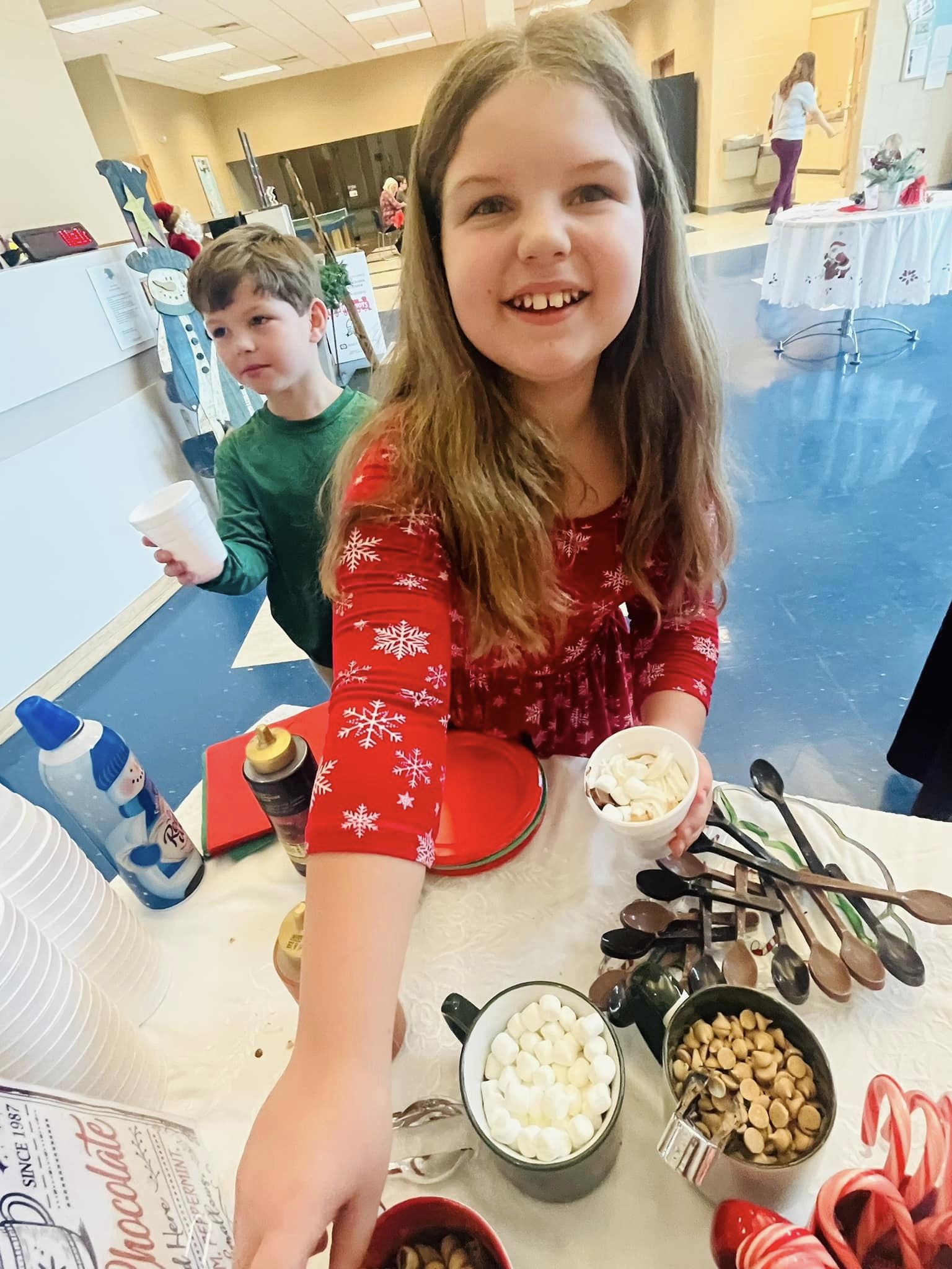Little girl and boy making a hot chocolate.  