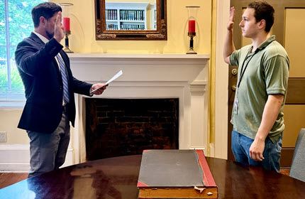 Judge Wall and Jaden Atkinson facing each other with right hand raised 